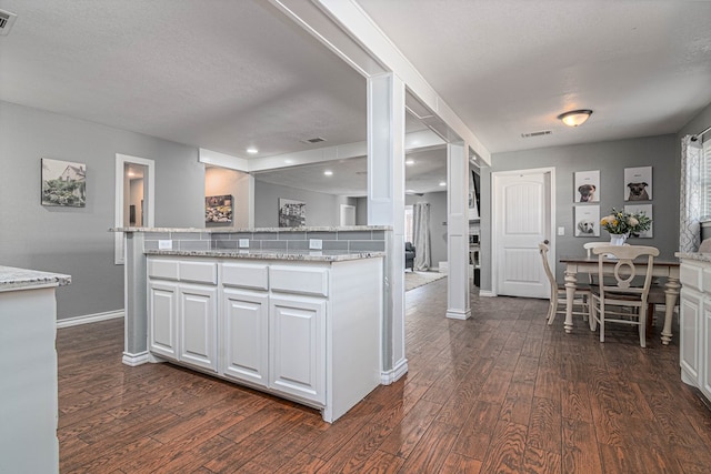 4100 Skyline Dr, Midland, TX 79707 - kitchen featuring dark wood finished floors, white cabinetry, light stone counters, and recessed lighting