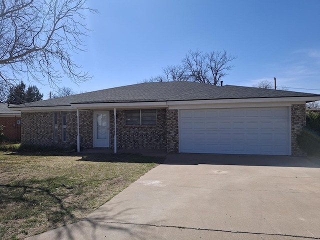 4011 Houston Ave, Snyder, TX 79549 - single story home with driveway, a front yard, a garage, and brick siding