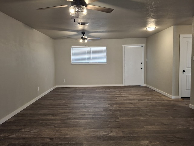 4011 Houston Ave, Snyder, TX 79549 - empty room with visible vents, baseboards, ceiling fan, dark wood-type flooring, and vaulted ceiling