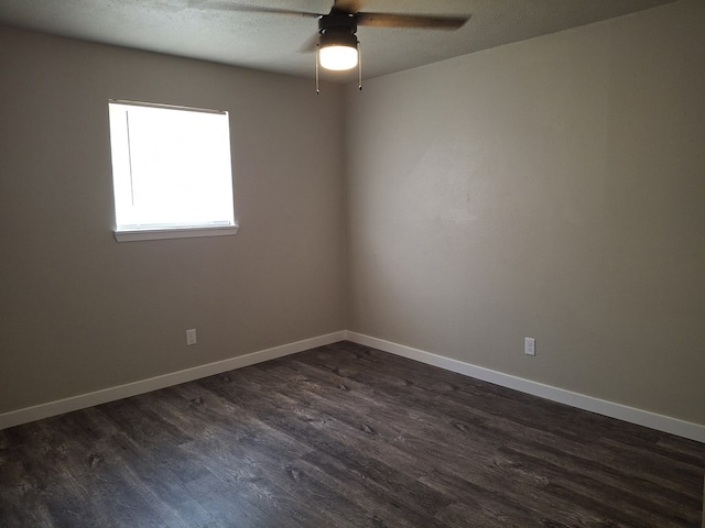 4011 Houston Ave, Snyder, TX 79549 - unfurnished room with dark wood-type flooring, ceiling fan, and baseboards