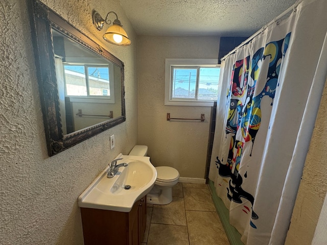 bathroom with vanity, a textured ceiling, tile patterned flooring, toilet, and curtained shower