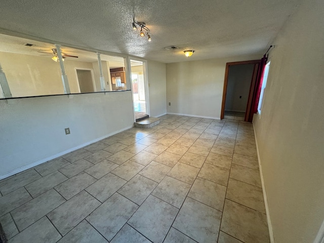 spare room with ceiling fan and a textured ceiling