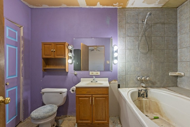 bathroom with a washtub, toilet, and vanity