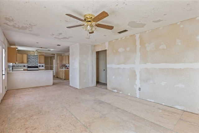 unfurnished living room featuring ceiling fan