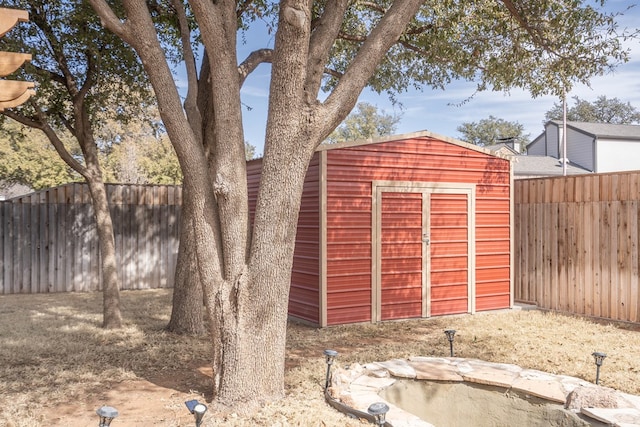 view of shed featuring a fenced backyard