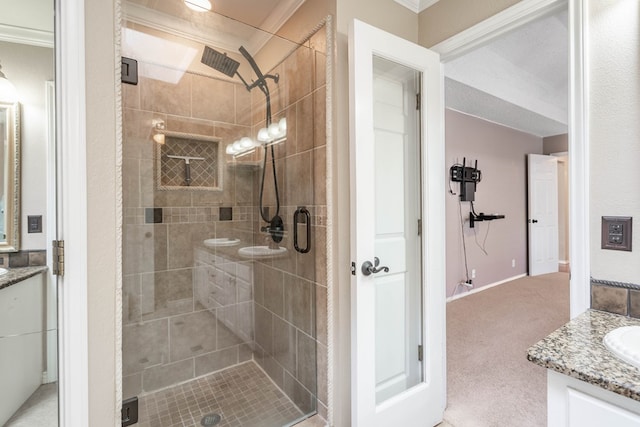 bathroom with a shower stall and vanity