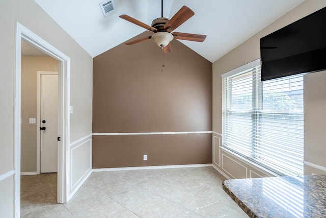 unfurnished room with visible vents, baseboards, ceiling fan, vaulted ceiling, and light tile patterned flooring