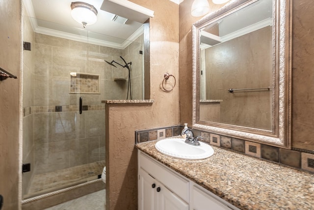 full bath with toilet, a stall shower, crown molding, and vanity