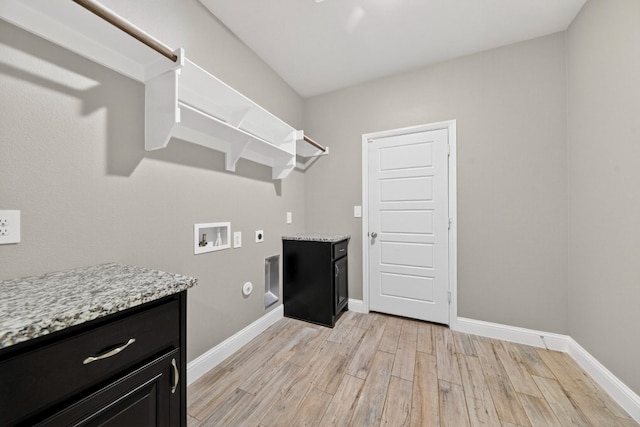 1803 Overshine Ln, Midland, TX 79705 - laundry room with electric dryer hookup, washer hookup, light wood-type flooring, cabinet space, and hookup for a gas dryer