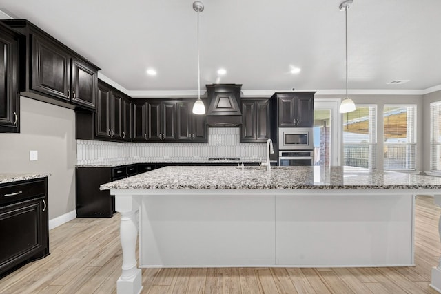 1803 Overshine Ln, Midland, TX 79705 - kitchen featuring appliances with stainless steel finishes, premium range hood, backsplash, light stone countertops, and ornamental molding