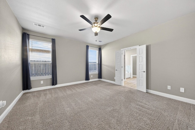 1803 Overshine Ln, Midland, TX 79705 - unfurnished bedroom with light carpet and a ceiling fan