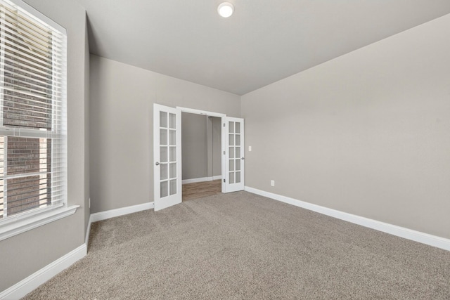 1803 Overshine Ln, Midland, TX 79705 - spare room with french doors and carpet flooring