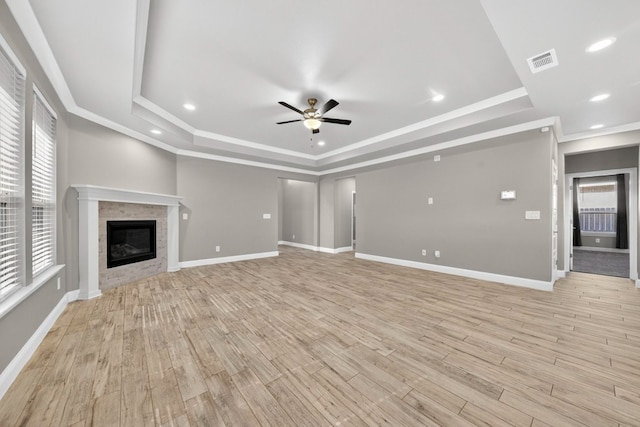 1803 Overshine Ln, Midland, TX 79705 - unfurnished living room with a raised ceiling, a ceiling fan, plenty of natural light, light wood finished floors, and ornamental molding