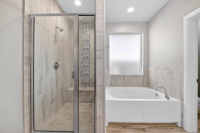 1803 Overshine Ln, Midland, TX 79705 - bathroom featuring a garden tub, a shower stall, wood finished floors, and recessed lighting