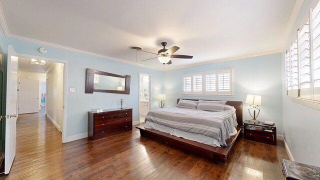 bedroom featuring baseboards, ornamental molding, and wood finished floors