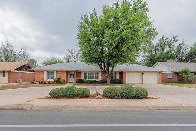 ranch-style house featuring brick siding, a garage, and concrete driveway