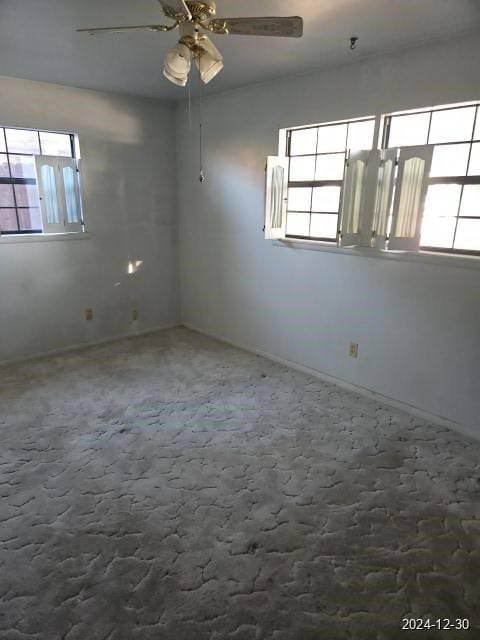 empty room with ceiling fan and carpet floors