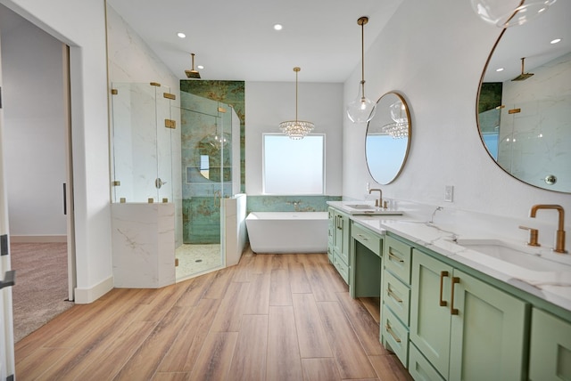 bathroom featuring vanity, wood-type flooring, and independent shower and bath