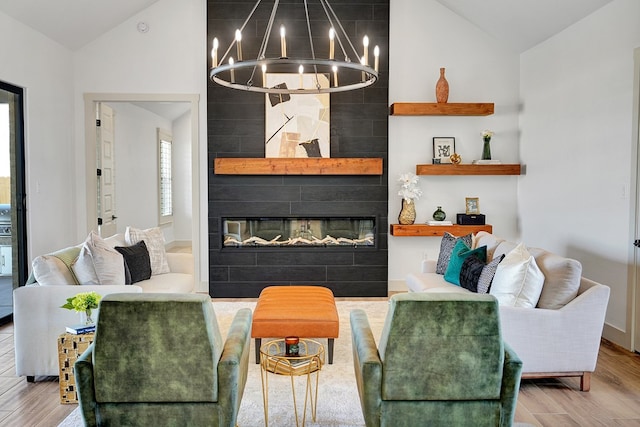 living room with wood-type flooring, a tiled fireplace, and vaulted ceiling