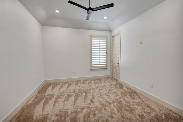 carpeted empty room featuring vaulted ceiling and ceiling fan