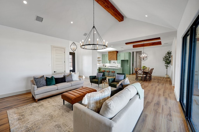 living room featuring an inviting chandelier, light hardwood / wood-style flooring, high vaulted ceiling, and beamed ceiling