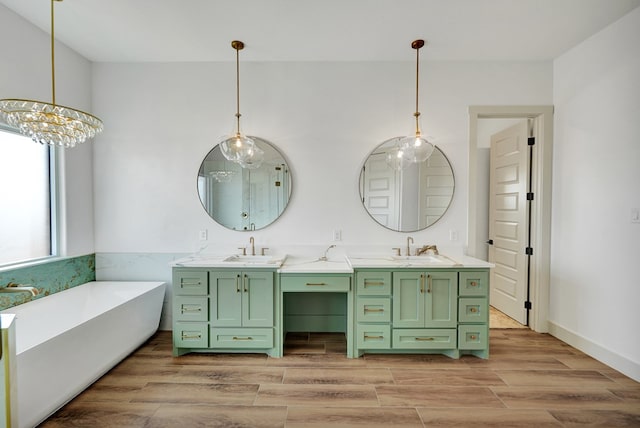 bathroom with wood-type flooring, a bath, and vanity