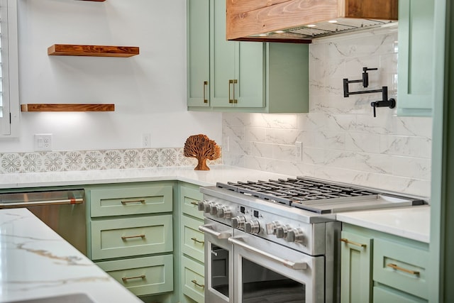 kitchen featuring appliances with stainless steel finishes, light stone countertops, custom range hood, green cabinetry, and decorative backsplash