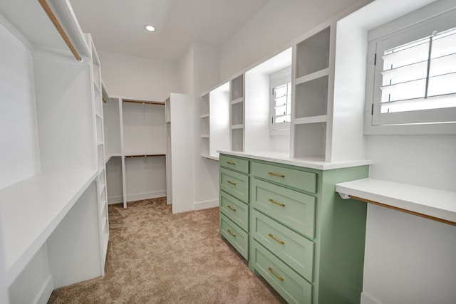 walk in closet featuring light colored carpet