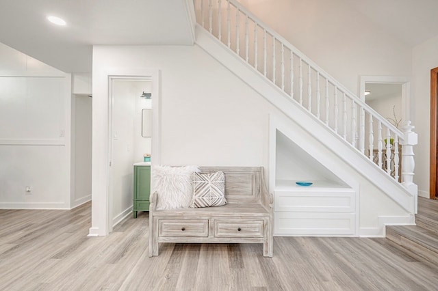stairway featuring recessed lighting, wood finished floors, and baseboards