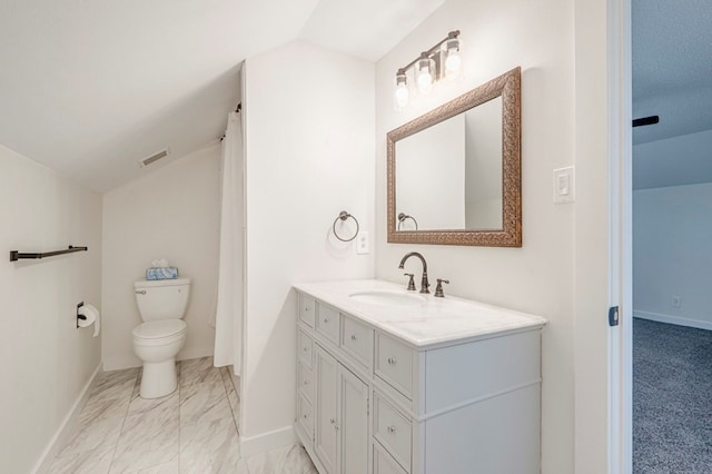 bathroom with vanity, toilet, visible vents, baseboards, and lofted ceiling