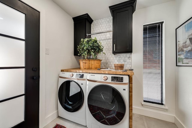 909 Pine Ct, Midland, TX 79705 - washroom featuring washer and clothes dryer, cabinet space, and light tile patterned flooring