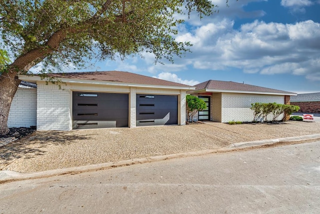 909 Pine Ct, Midland, TX 79705 - view of front of home featuring brick siding, driveway, and an outbuilding