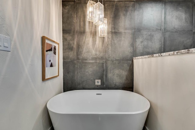 909 Pine Ct, Midland, TX 79705 - full bath with a freestanding bath and a chandelier