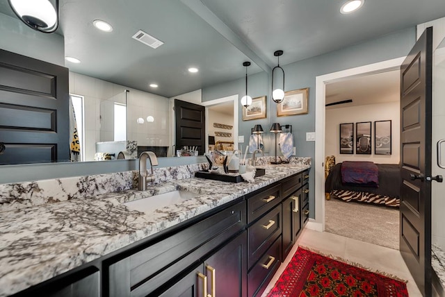 909 Pine Ct, Midland, TX 79705 - full bathroom with ensuite bathroom, double vanity, recessed lighting, tile patterned floors, and walk in shower