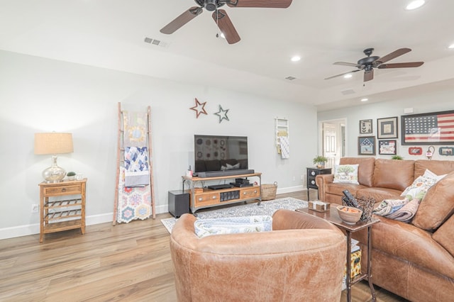 living room featuring ceiling fan and light hardwood / wood-style flooring