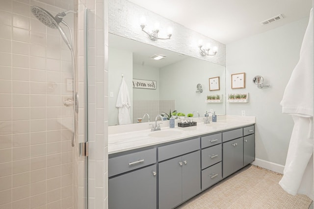 bathroom with tile patterned floors, vanity, and a shower with door