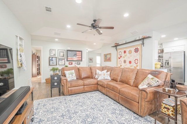 living room with ceiling fan and light hardwood / wood-style flooring