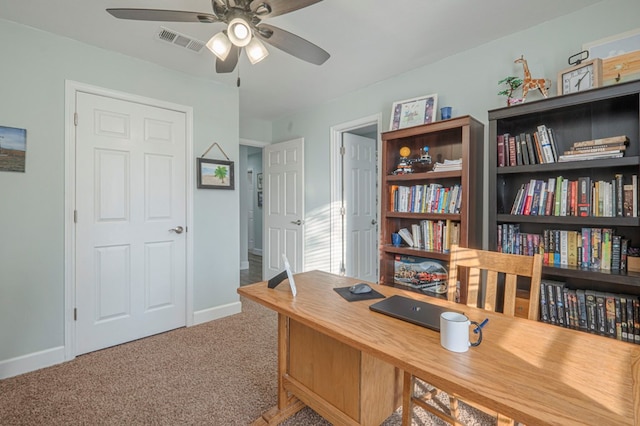 carpeted office space with ceiling fan