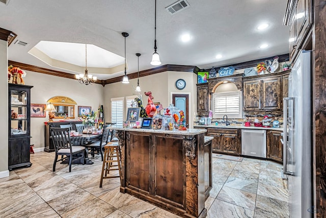 1210 S County Rd 1117, Midland, TX 79706 - kitchen featuring appliances with stainless steel finishes, crown molding, healthy amount of natural light, a chandelier, and dark brown cabinets