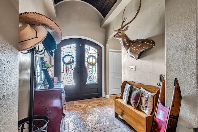 1210 S County Rd 1117, Midland, TX 79706 - foyer entrance with french doors, arched walkways, lofted ceiling, and a textured wall