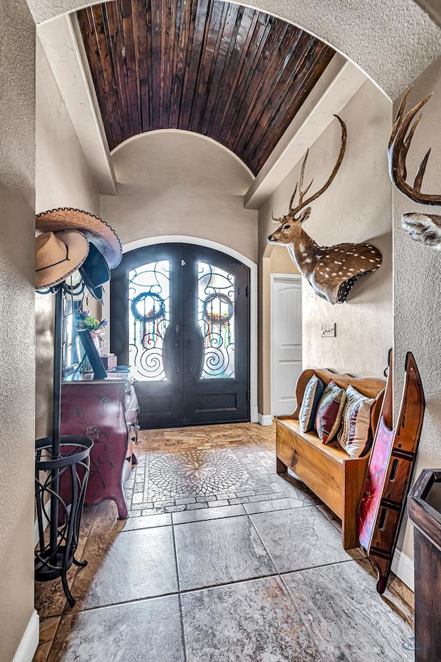 1210 S County Rd 1117, Midland, TX 79706 - entryway with french doors, vaulted ceiling, a textured wall, baseboards, and arched walkways