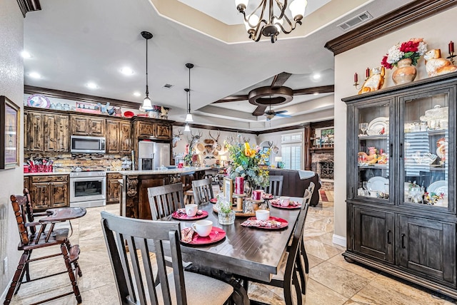 1210 S County Rd 1117, Midland, TX 79706 - dining area featuring a raised ceiling, a chandelier, a ceiling fan, ornamental molding, and light tile patterned floors