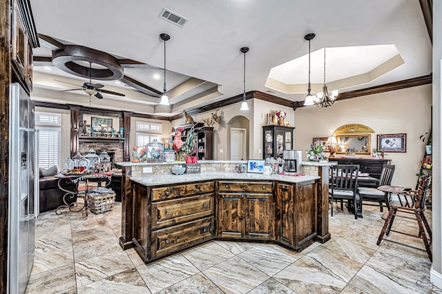 1210 S County Rd 1117, Midland, TX 79706 - kitchen featuring ornamental molding, a raised ceiling, arched walkways, dark brown cabinetry, and a ceiling fan