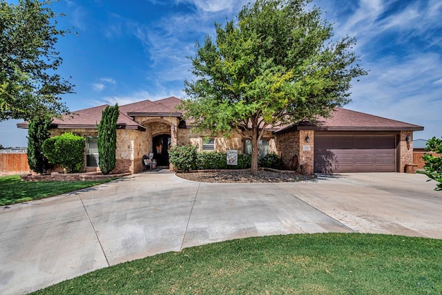 1210 S County Rd 1117, Midland, TX 79706 - view of front of home with driveway, an attached garage, and brick siding
