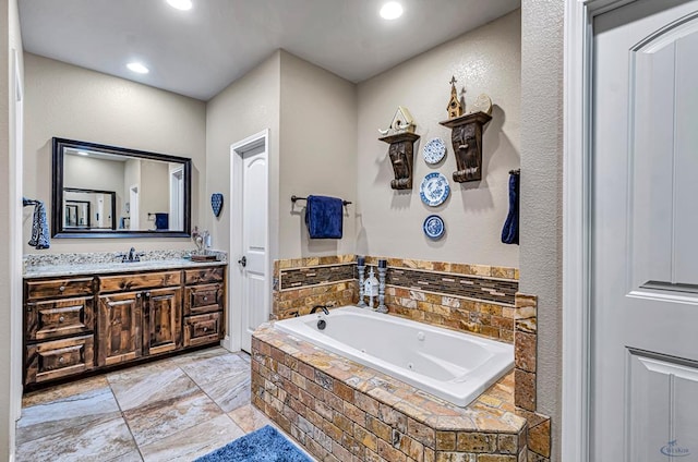 1210 S County Rd 1117, Midland, TX 79706 - bathroom featuring a tub with jets, vanity, and recessed lighting