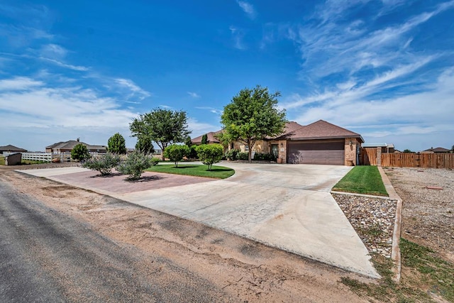 1210 S County Rd 1117, Midland, TX 79706 - view of front of property with concrete driveway, a garage, and brick siding