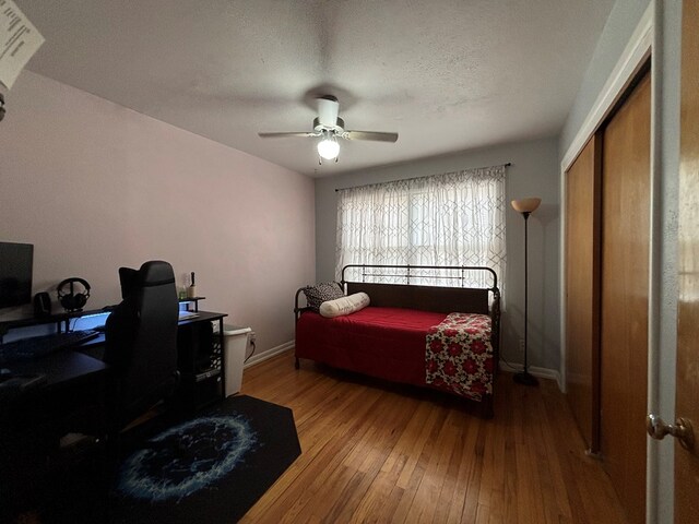 1806 38th St, Snyder, TX 79549 - bedroom featuring hardwood / wood-style floors, a desk, baseboards, ceiling fan, and a closet