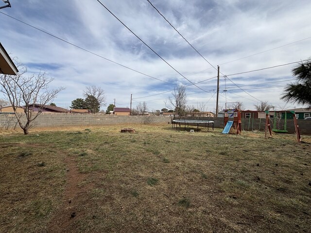 1806 38th St, Snyder, TX 79549 - view of yard featuring a trampoline and a playground