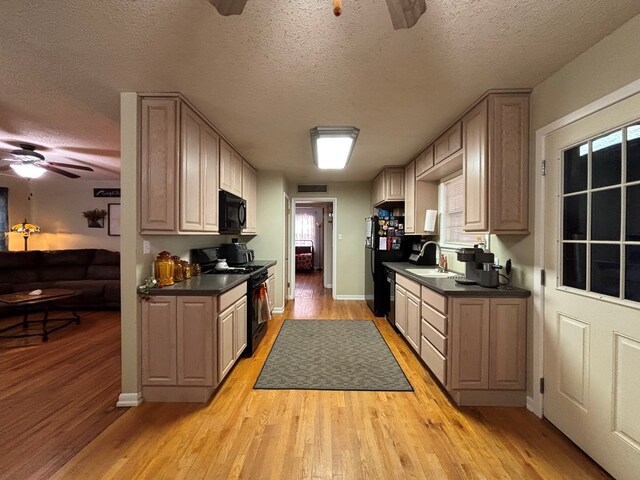1806 38th St, Snyder, TX 79549 - kitchen featuring ceiling fan, black appliances, a sink, dark countertops, and a textured ceiling