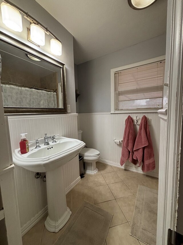 1806 38th St, Snyder, TX 79549 - bathroom with tile patterned flooring, toilet, wainscoting, and a shower with curtain